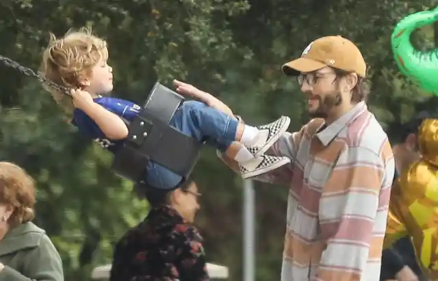 #15. Ashton Kutcher Swings His Son On The Swing